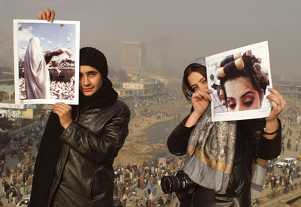 Two of Aina's photographers, <b>Farzana Wahidy</b> and <b>Freshta Kohistany</b>, present contrasting images of contemporary Afghan womanhood. Behind them is the Kabul River Bazaar.