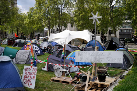 Having been finally evicted from Kew – after 11 months - the  activists descend on the heart of British democracy and establish a new  sustainable site in the shadow of the Houses of Parliament. May 2010.
