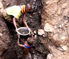 Turkana women fetch contaminated water from an underground spring.