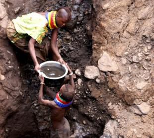 Turkana women fetch contaminated water from an underground spring.
