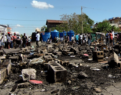 Camp Lycèe Toussaint after an arson attack on March 12. Photo: Mark Synder.