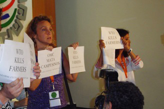 James holding sign: “WTO Kills Farmers” 