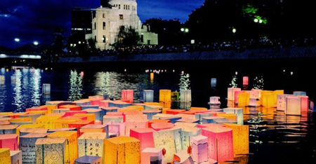 Paper lanterns to mourn the atomic bomb victims float in the Motoyasu River in front of the Atomic Bomb Dome in Hiroshima 