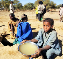 Malian Refugee collects water