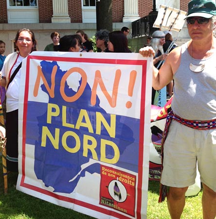 Outside Governors' Conference in Burlington, VT, Innu grandmother Ellyse Vollant from Northern Quebec and Charlie Megeso of the Nulhegan Abenaki hold sign against Plan Nord. Photo: Will Bennington 