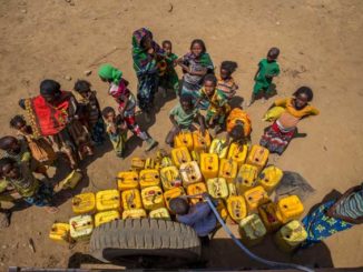 On 9 February 2016 in central Ethiopia, children and women from a semi-pastoralist community wait their turn to fill jerrycans with clean water at a water point in Haro Huba Kebele in Fantale Woreda, in East Shoa Zone, Oromia Region. Credit: © UNICEF/UN011590/Ayene