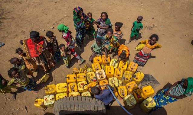 On 9 February 2016 in central Ethiopia, children and women from a semi-pastoralist community wait their turn to fill jerrycans with clean water at a water point in Haro Huba Kebele in Fantale Woreda, in East Shoa Zone, Oromia Region. Credit: © UNICEF/UN011590/Ayene