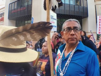Shannon Rivers protested Trump at the Phoenix rally on Tuesday. For Rivers, a tribal citizen of the Akimel O’odham of the Gila River Indian Community, the alliance between indigenous people and Latinos is personal. “Many [Latinos] are our family,” he said. Photo by Jenni Monet.