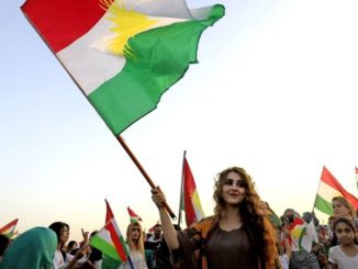 Syrian Kurds in the northeastern Syrian city of Qamishli wave the Kurdish flag in celebration on September 26, 2017 in support of the independence referendum in Iraq's autonomous northern Kurdish region. (Credit: Delil Souleiman/AFP/Getty Images)