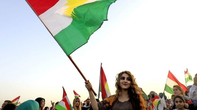 Syrian Kurds in the northeastern Syrian city of Qamishli wave the Kurdish flag in celebration on September 26, 2017 in support of the independence referendum in Iraq's autonomous northern Kurdish region. (Credit: Delil Souleiman/AFP/Getty Images)