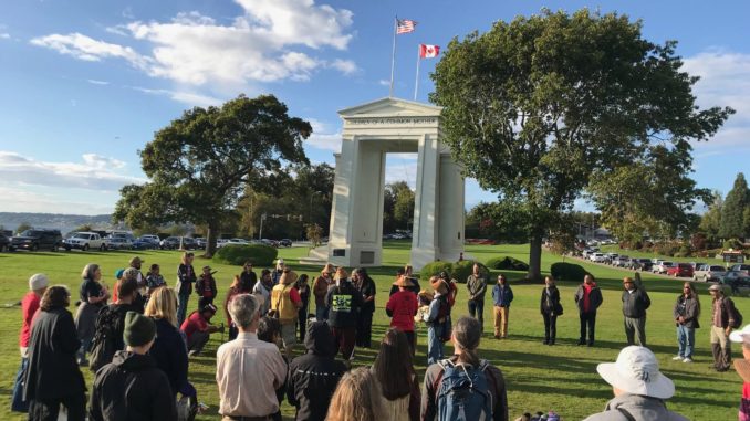 Canadian and U.S. activists rallying together on October 1 at Peace Arch Park, where citizens from both countries can walk freely. Photo courtesy of Salish Sea Whale Sanctuary