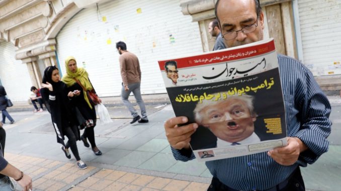 Reading the news in Iran. (Credit: STR / AFP/GETTY IMAGES)