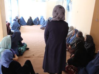 A coordinator with the Afghan Peace Volunteers invites Afghan mothers in Kabul to speak about the difficulties they face. Credit: Afghan Peace Volunteers
