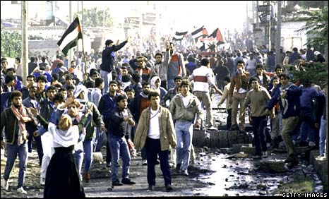 Palestinians emerge from the Nusseirat refugee camp during the first antifada.