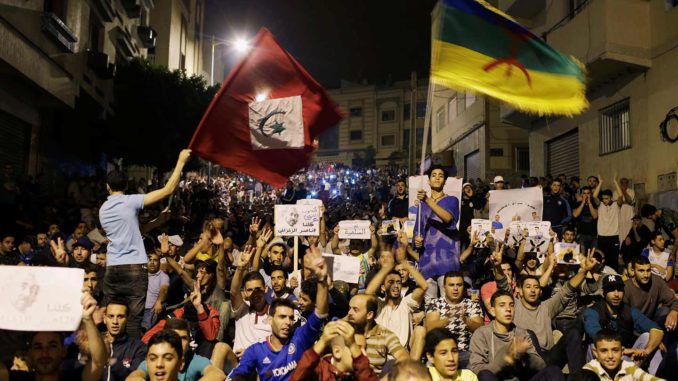 Protesters raise the flag of the Rif Republic (left) and the pan-Berber tricoleur (right) at a demonstration in the northern town of Al-Hoceima, Morocco, June 1, 2017. (Reuters / Youssef Boudlal)