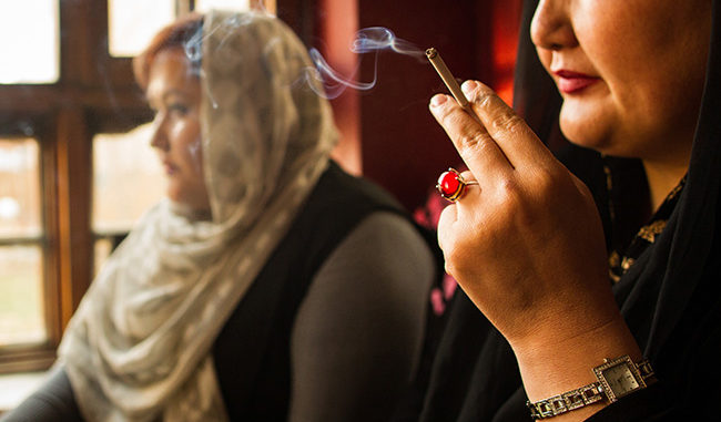Women smoke inside Laila Haidary's restaurant on March 13 2017 in Kabul, Afghanistan. Smoking is considered a taboo for women, especially in public.