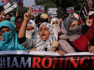 Indian activists hold placards during a protest march against the persecution of Myanmar's Rohingya. (Credit: EPA-EFE/Rajat Gupta)