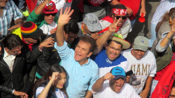 Salvador Nasralla, the Opposition Alliance Against the Dictatorship candidate widely believed to have actually won the presidency, waves to onlookers at a December 10th march against election fraud in Tegucigalpa. Photo by Sandra Cuffe