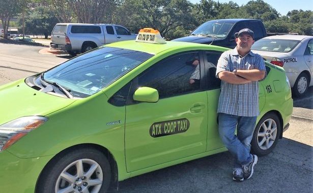 ATX Coop Taxi driver Ebrahim Elhadidi standing in front of his car in Austin, Texas. (WNV/Dave Passmore)