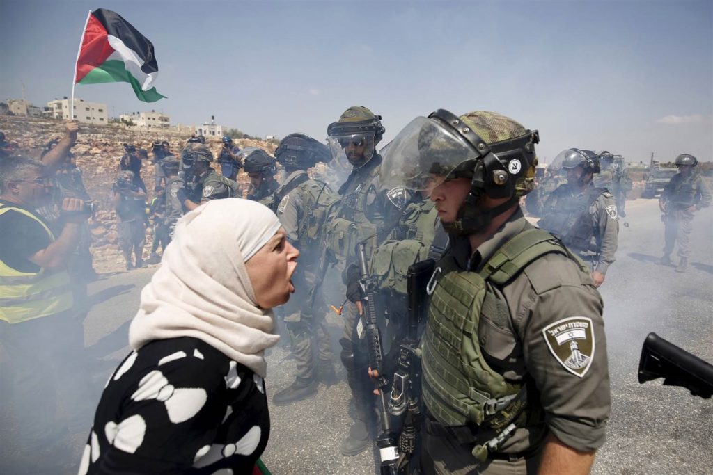 A Palestinian woman argues with an Israeli border police officer during a protest against Jewish settlements in the West Bank village of Nabi Saleh on Sept. 4, 2015. Credit: Mohamad Torokman / Reuters