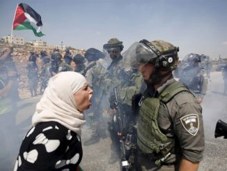 A Palestinian woman argues with an Israeli border police officer during a protest against Jewish settlements in the West Bank village of Nabi Saleh on Sept. 4, 2015. Credit: Mohamad Torokman / Reuters