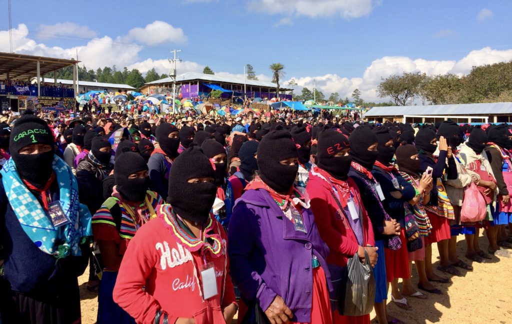 Zapatista women and thousands of women from around the world listen to the opening address kicking off the first International Political, Artistic, Sporting, and Cultural Gathering of Women who Struggle in the Zapatista Caracol in the Tzots Choj region, Chiapas, Mexico, March 8, 2018. Photo by Heather Gies