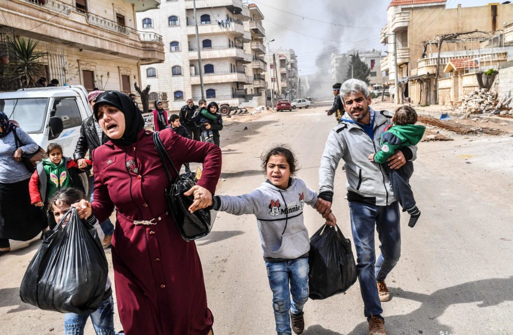 Civilians running for cover during the attack on Afrin in March. CreditBulent Kilic/Agence France-Presse — Getty Images 