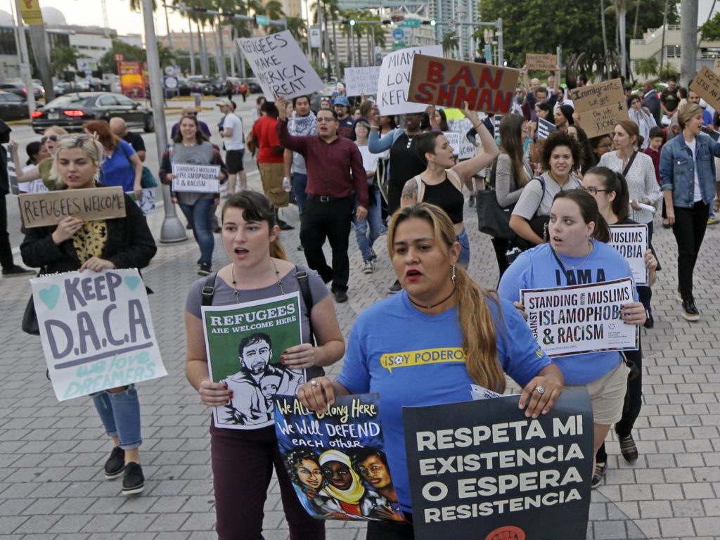 Protesters chant slogans against President Donald Trump's executive order on immigration Thursday, Jan. 26, 2017, in downtown Miami. The protesters manifested their opposition to Trump's executive order restricting immigration from some Middle Eastern and African countries. (AP Photo/Alan Diaz)