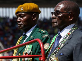 Zimbabwean President Robert Mugabe (right) at the country's independence anniversary in 2016. From early 1983 to late 1987, the Zimbabwe National Army carried out a series of massacres of Ndebele civilians called the Gukurahundi, deriving from a Shona language term which loosely translates to "the early rain which washes away the chaff before the spring rains". (Photo credit: Jekesai Njikizana/AFP/Getty)