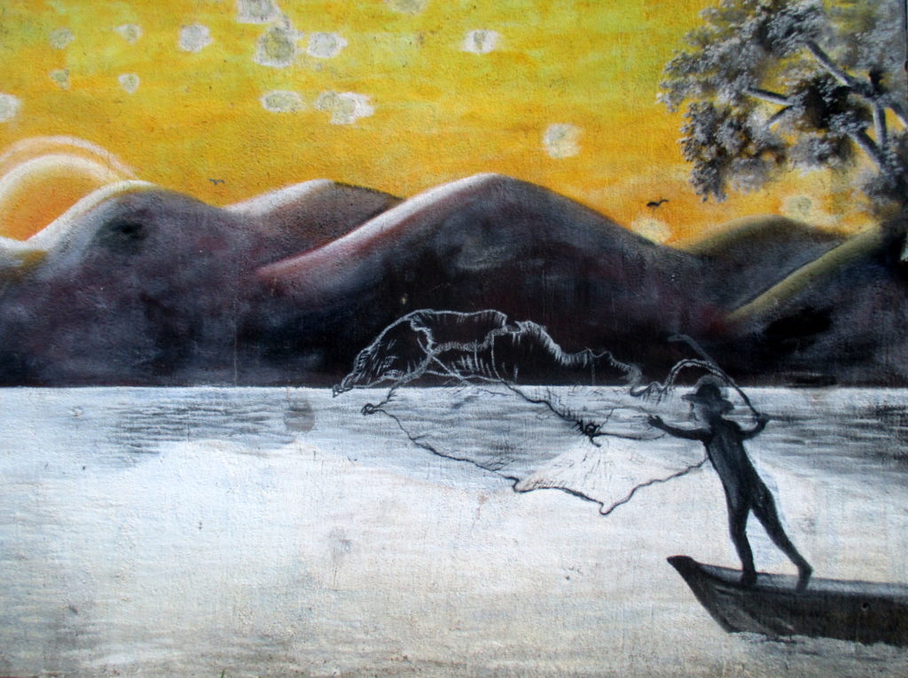A mural in El Estor depicts a fisherman casting his net into Lake Izabal, in eastern Guatemala. Photo: Sandra Cuffe