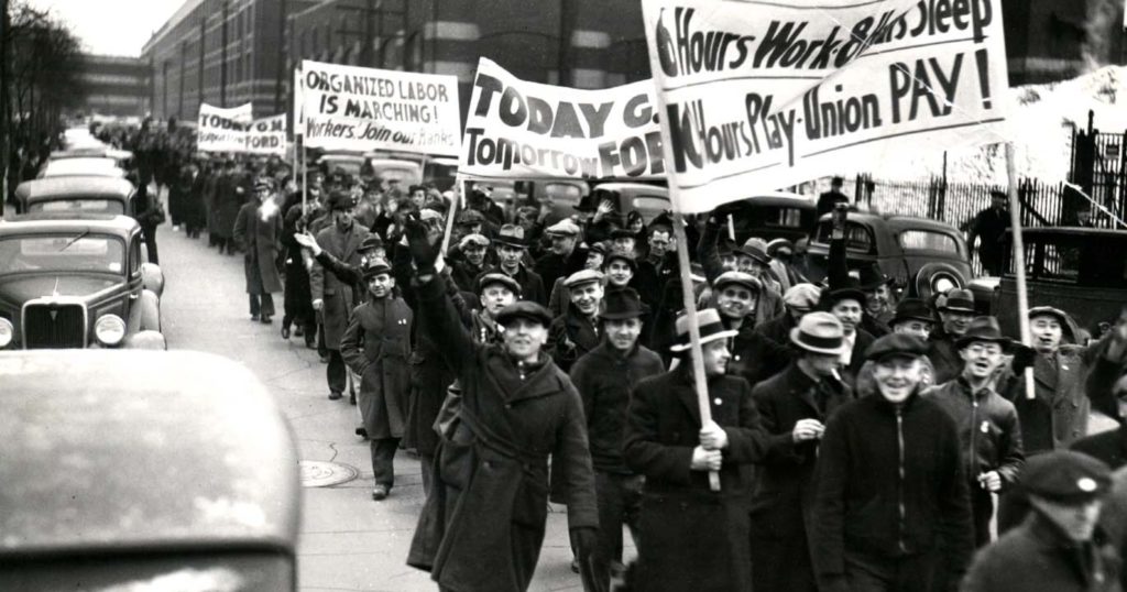 Union demonstrators march outside the Fleetwood and Cadillac plan in Detroit during a General Motors strike in 1936. Credit: The Detroit News