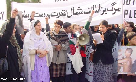 On International Human Rights Day, December 10, 2003, Afghan women of the Revolutionary Association of Women of Afghanistan (RAWA) marched to the UN headquarters in Islamabad, Pakistan. The sign states in Persian: "Down with the Northern Alliance, power to the Afghan people!" / credit: RAWA