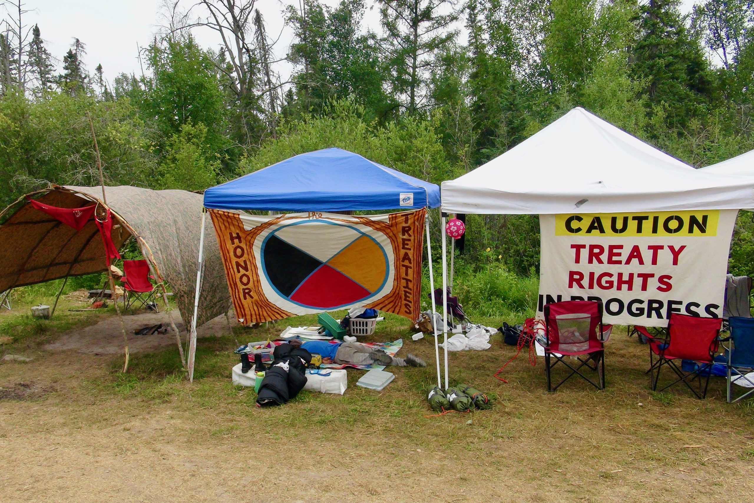 Caption needed. Signs at the camp read, “Honor Treaties” and “Caution: Treaty Rights in Progress.”