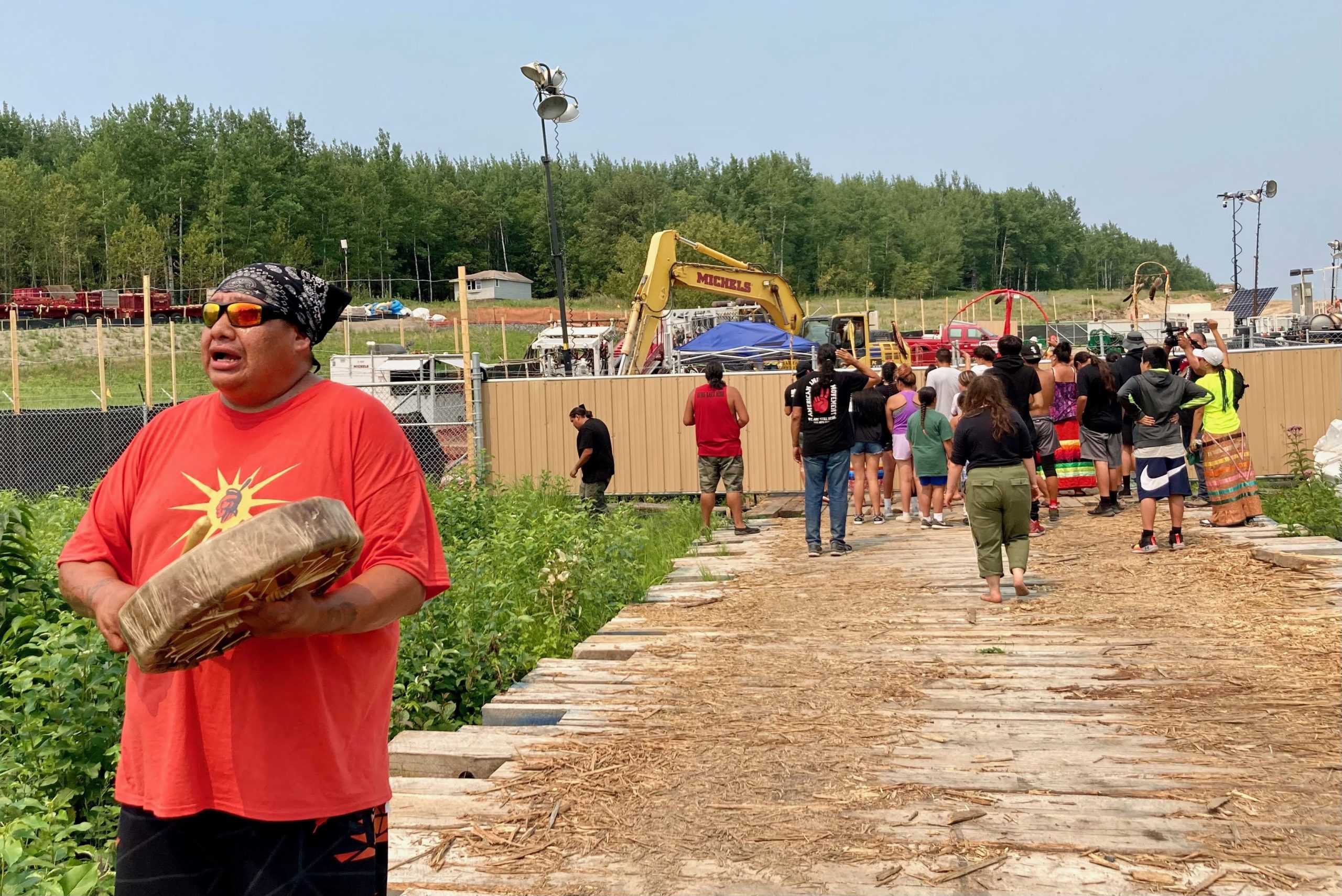 Dakota singer Hoka Wicasa sings as youth runners from Standing Rock and Cheyenne River Nations in North and South Dakota approach an Enbridge work site near Camp Firelight. The youth ran the pipeline route across Minnesota from North Dakota to Wisconsin, stopping at all of the water protector camps across the region.