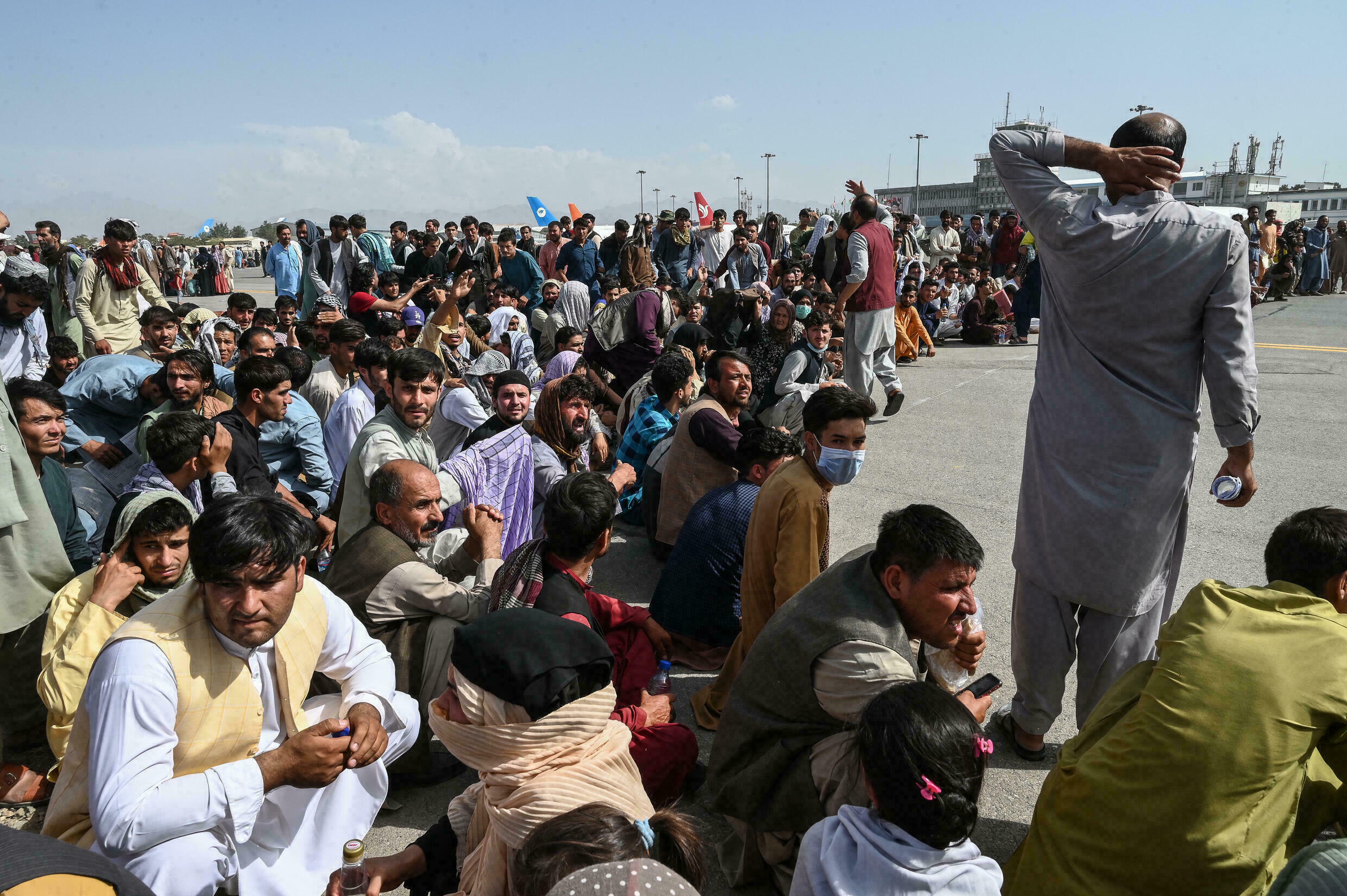 Thousands of Afghans crowded on August 16 at the Hamid Karzai International Airport in Kabul to exit Afghanistan after the Taliban entered the capital / credit: AFP/Wakil Kohsar