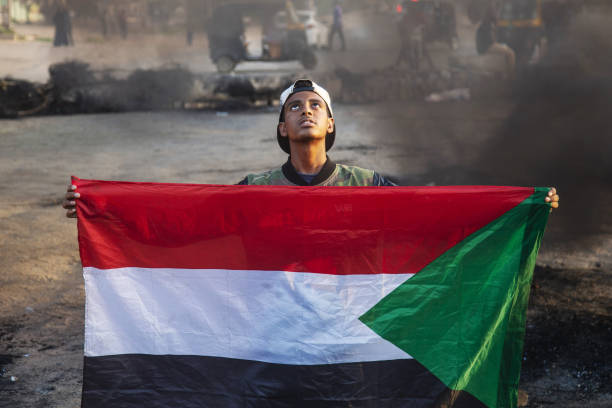 Protester holding the Sudanese flag in Khartoum after the October 25 coup / credit: Revolutionary masses of Sudan