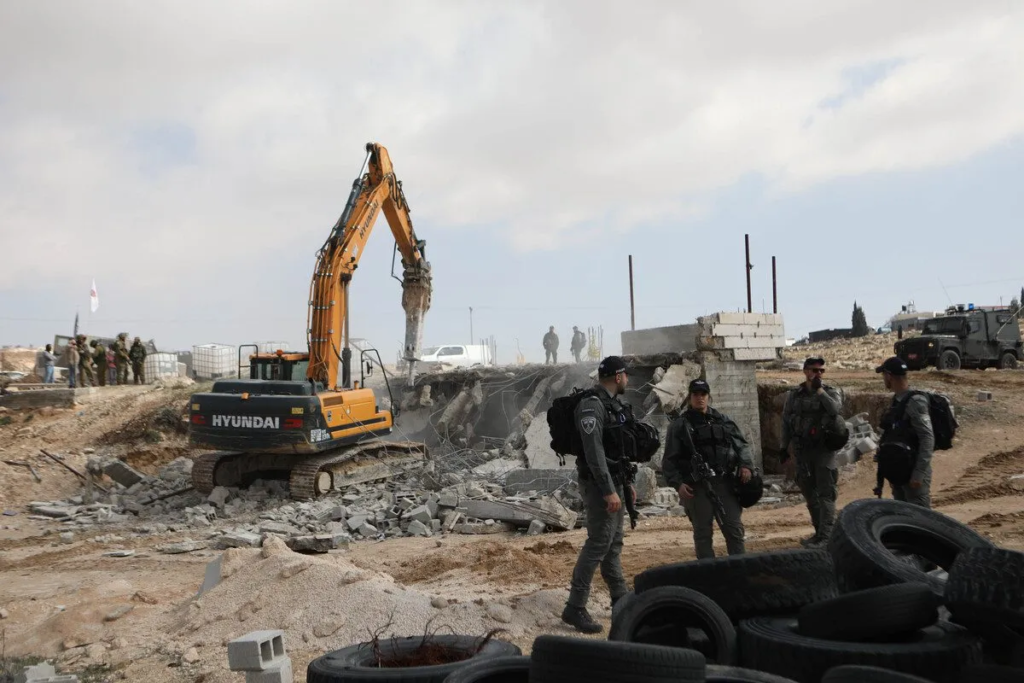 Israeli forces try to disperse Palestinian residents as a Palestinian building, located in Zif village, is demolished by Israel allegedly for being "unlicensed," in Hebron, West Bank on February 15 / credit: Mamoun Wazwaz / Anadolu Agency