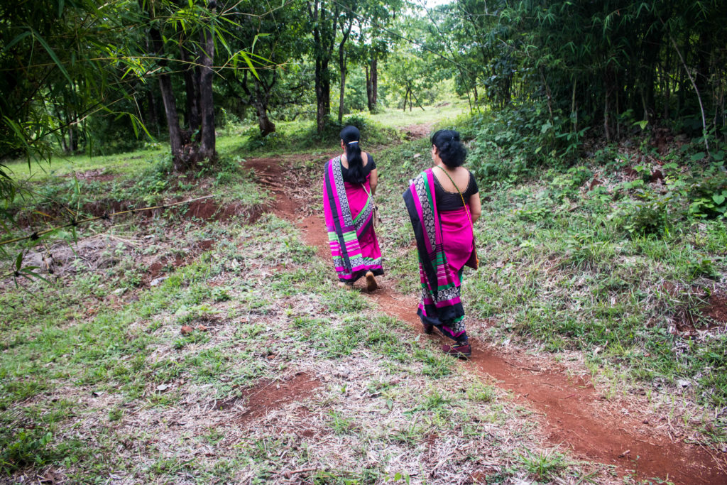 ASHA workers Rekha Dorugade and Mandakini Kodak trekking the Dhangarwada hill to complete their survey, a steep patch of five kilometers in Kolhapur’s Pernoli village / credit: Sanket Jain