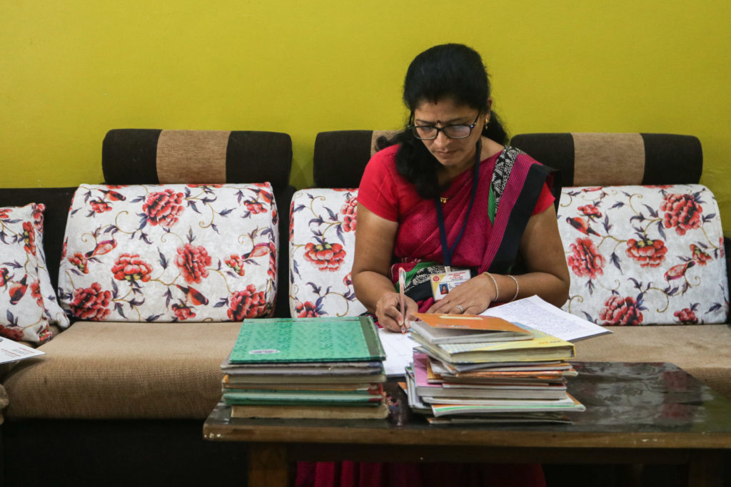 A significant part of ASHA Prajakta Khade’s time goes into writing the medical records. “If any record is incomplete, our seniors immediately probe an inquiry, and even the pay is deducted,” she says / credit: Sanket Jain