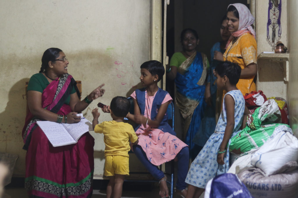 Pushpavati distributes iron and folic acid tablets to her community members / credit: Sanket Jain