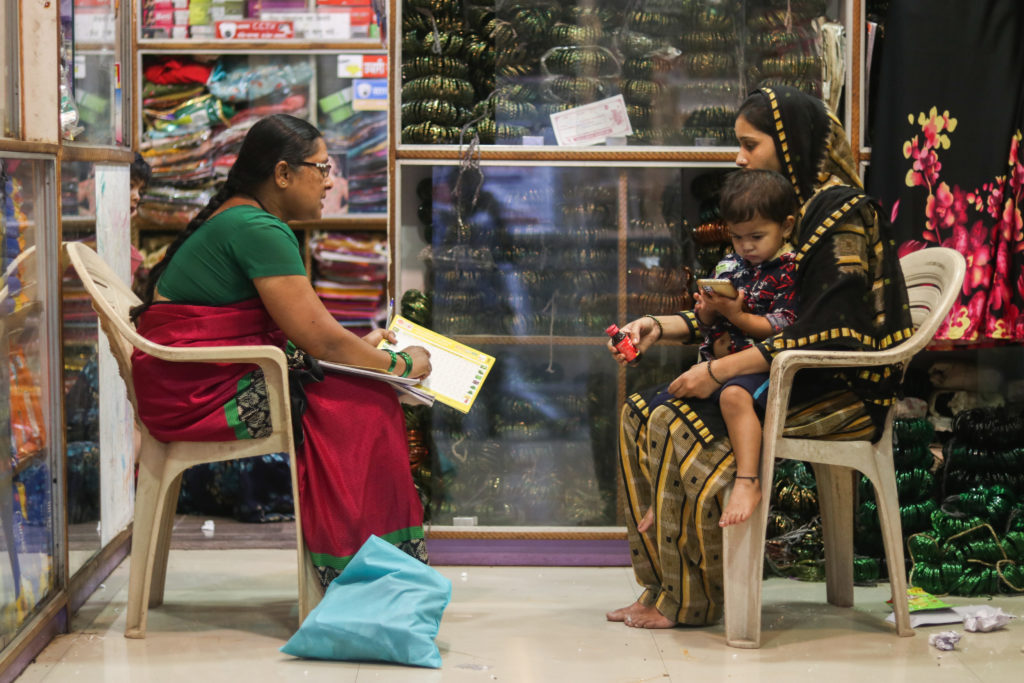 ASHA workers always counsel the community members on proper healthcare. Here Pushpatai is talking to a woman about early childhood health in Kolhapur’s Shirol region / credit: Sanket Jain