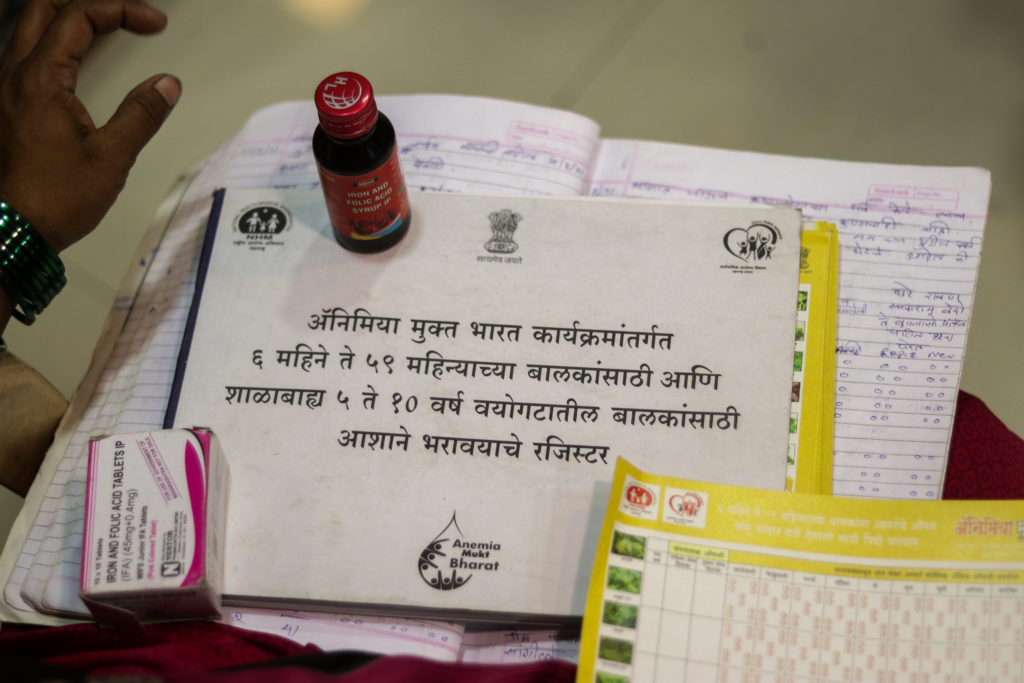 As part of the health ministry’s Anemia free India program, ASHAs are given a long notebook to maintain the records of 6-51 week old infants and 5-10-year-old children from their community. ASHAs regularly provide them with adequate medicines to prevent Anemia / credit: Sanket Jain