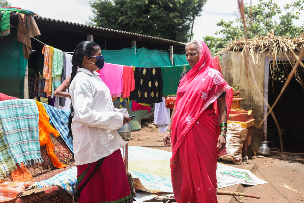 ASHA Kavita Patil talking to senior citizens in Kolhapur’s Bhendavade village to understand the mental toll of two floods / credit: Sanket Jain