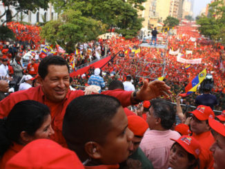 Venezuelan President Hugo Chavez (center) waves to supporters during a rally held on April 14, 2007, outside the Miraflores Palace in Caracas. It was held here to celebrate the fifth anniversary of the return of democracy after a short-lived coup against Chavez was thwarted in 2002 / credit: Bolivar News Agency/Xinhua Press/Corbis