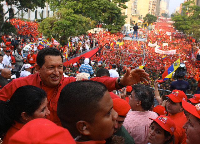 Venezuelan President Hugo Chavez (center) waves to supporters during a rally held on April 14, 2007, outside the Miraflores Palace in Caracas. It was held here to celebrate the fifth anniversary of the return of democracy after a short-lived coup against Chavez was thwarted in 2002 / credit: Bolivar News Agency/Xinhua Press/Corbis