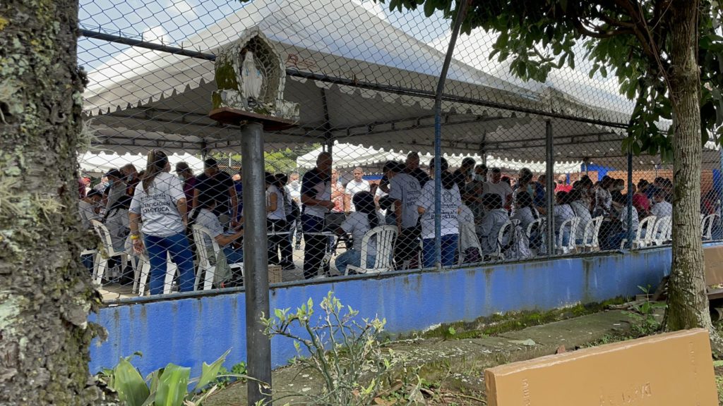 A rear view of election workers at a polling site at Ciudadela Comfandi, a neighborhood in Calí / credit: Julie Varughese