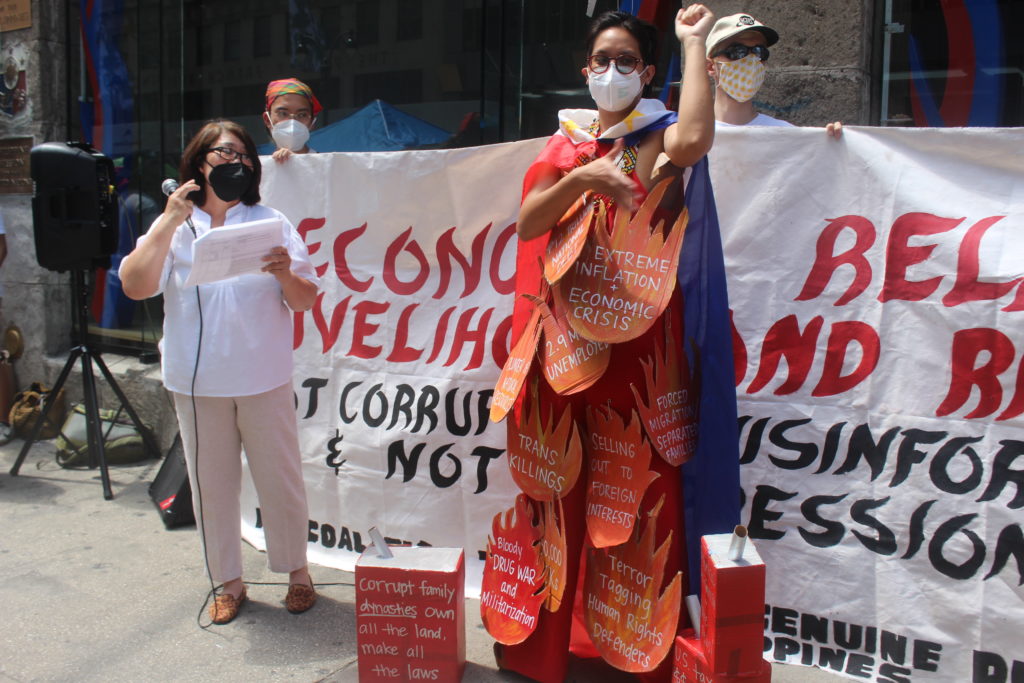 A Filipino protester at the Philippine consulate in New York City wears an effigy to call out human-rights violations in the Philippines / credit: Cygaelle Bergado