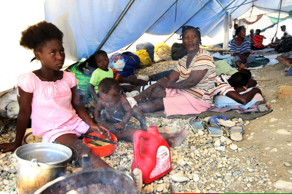 Displaced Haitians not yet assigned individual tents share in 2010 a large tent house at a camp site in Croix-des-Bouquets, Haiti / credit: Sophia Paris / United Nations