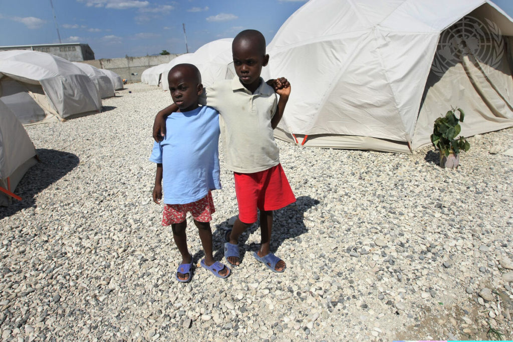 Children in 2010 in a camp site in Croix-des-Bouquets, Haiti. At the time, 4,000 displaced Haitians resettled at the site, collaboratively built and maintained by the International Organization for Migration, ShelterBox and civil defense forces from the Dominican Republic / credit: Sophia Paris / United Nations