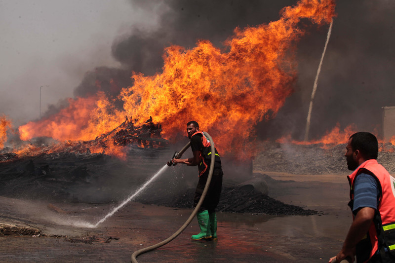 Firefighters in Gaza tackled in 2014 a fire caused by an Israeli missile strike on an United Nations Relief and Works Agency for Palestine Refugees in the Near East storehouse / credit: Ashraf Amra / APA images